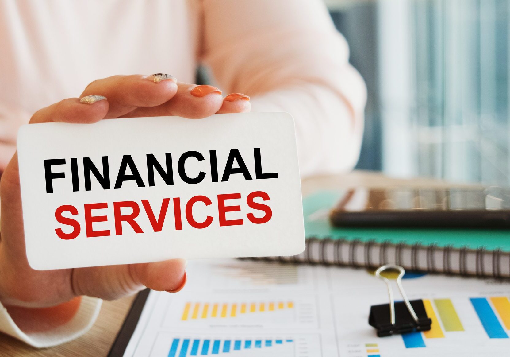 Hand holding financial services sign